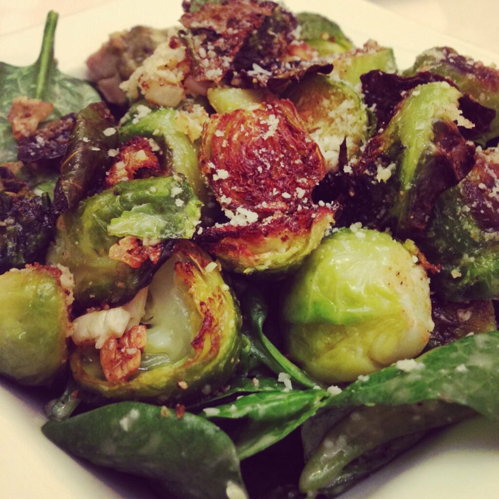 Spinach Caesar Salad topped with Roasted Brussel Sprouts