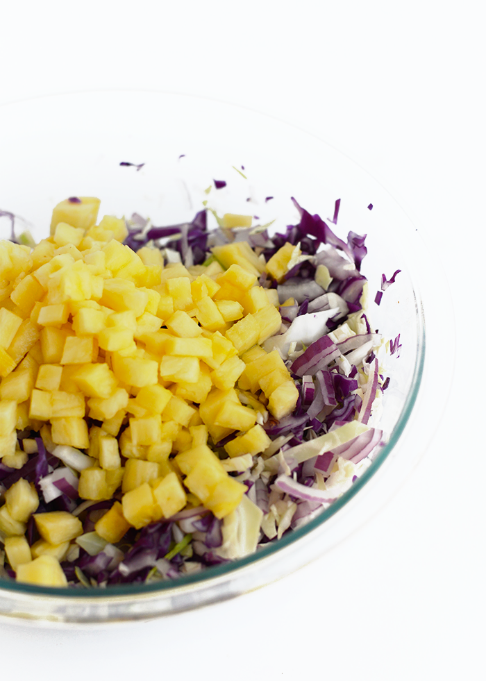This clean-eating, paleo coleslaw is made with homemade mayo, a mixture of delicious and colorful vegetables and a pop of pineapple for sweetness!