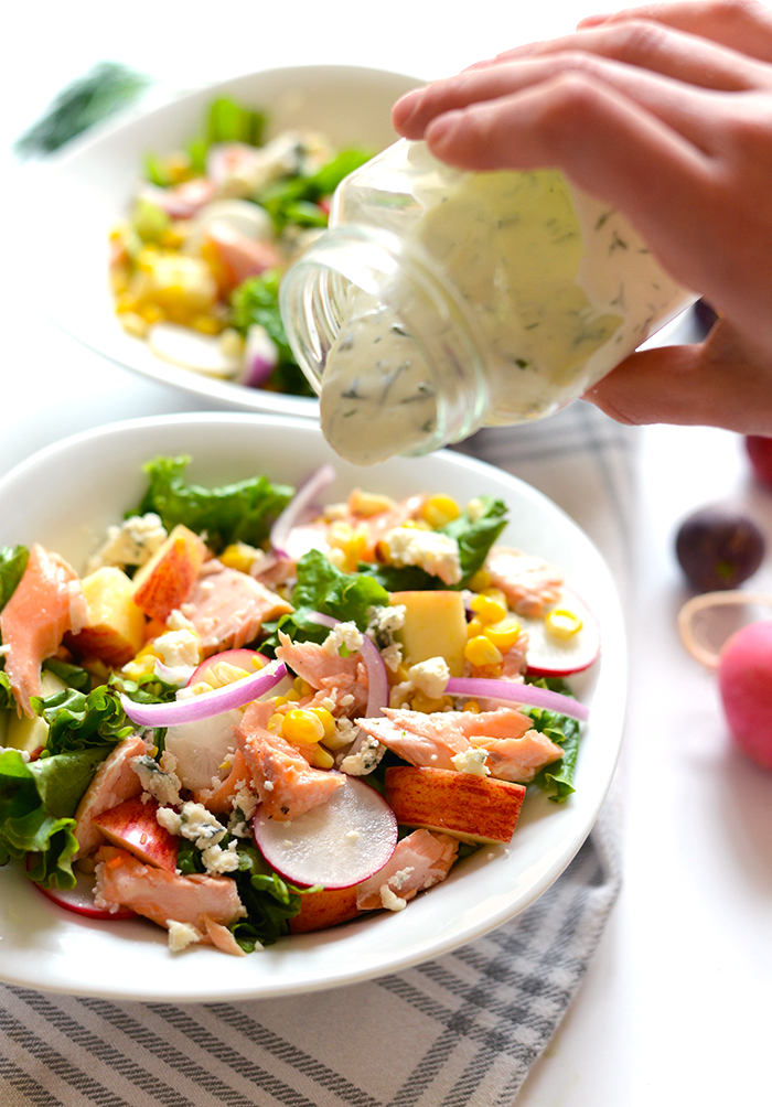 This delicious salmon salad is packed with flavor from grilled corn to fresh radishes to apple chunks and is topped with a healthy, homemade Greek yogurt dill dressing!