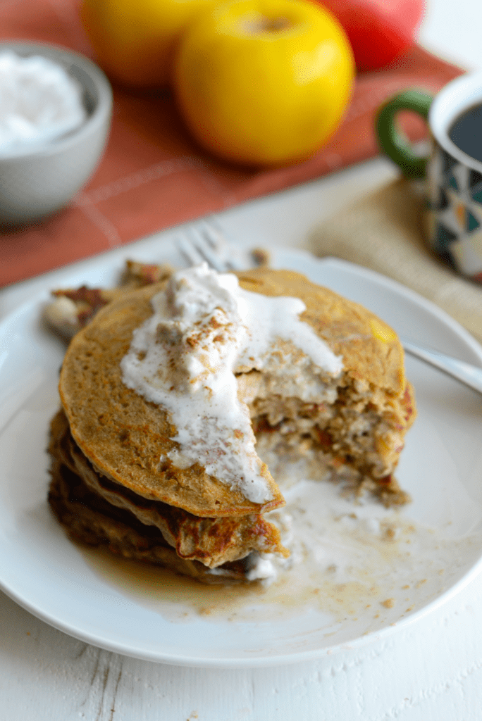 These Gluten-Free Apple Cinnamon Oat Pancakes are hearty and delish. They are made with 100% whole grains, no refined sugars, and real apple chunks!