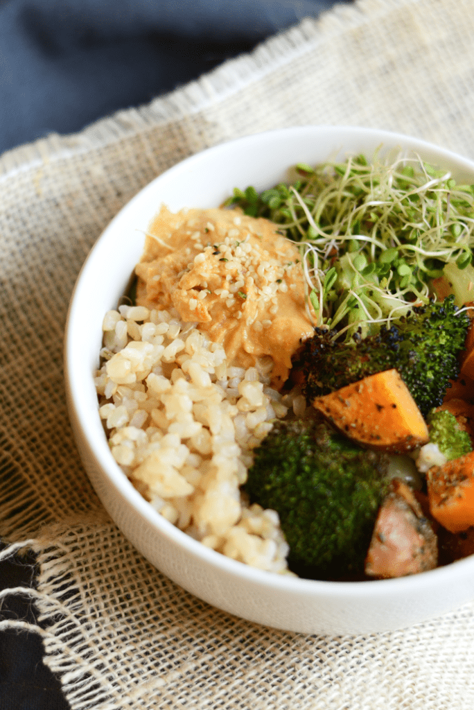 Vegetarian Brown Rice Bowl with roasted veggies, hummus, hemp seeds, and sprouts!