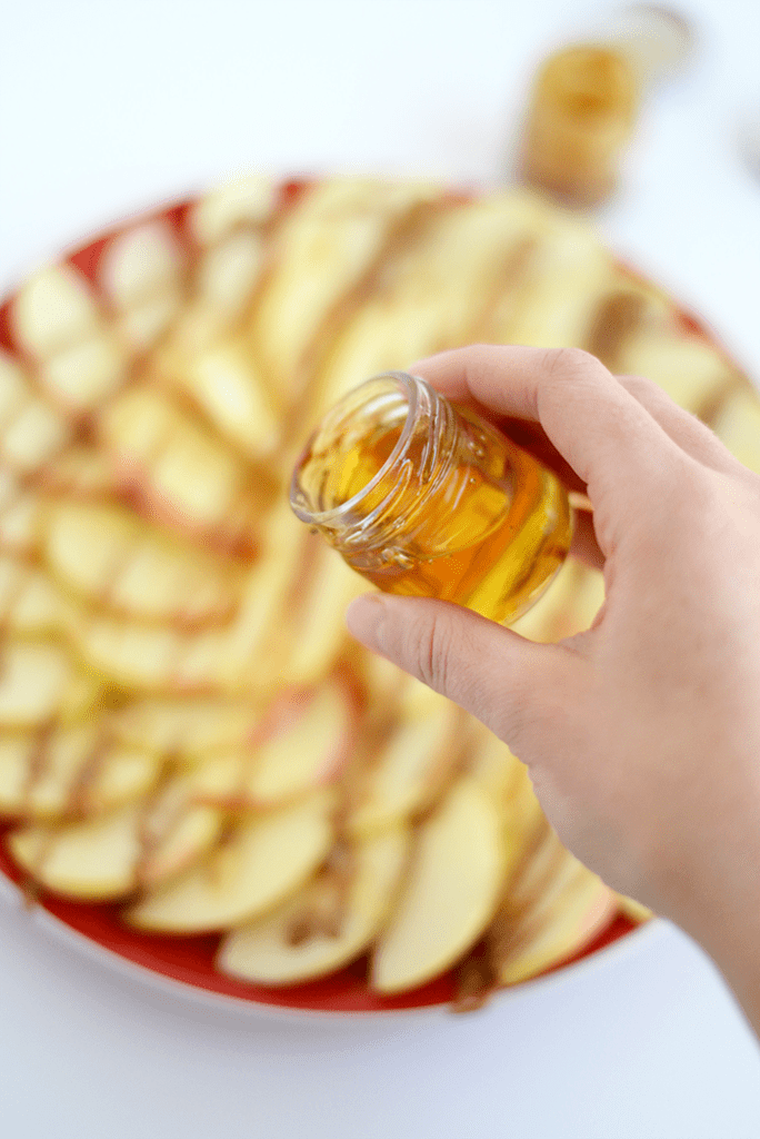 Looking for a healthy, kid-friendly snack idea? Slice up some apples and dress them up with nut butter, honey, seeds, and dried fruit to make apple nachos!