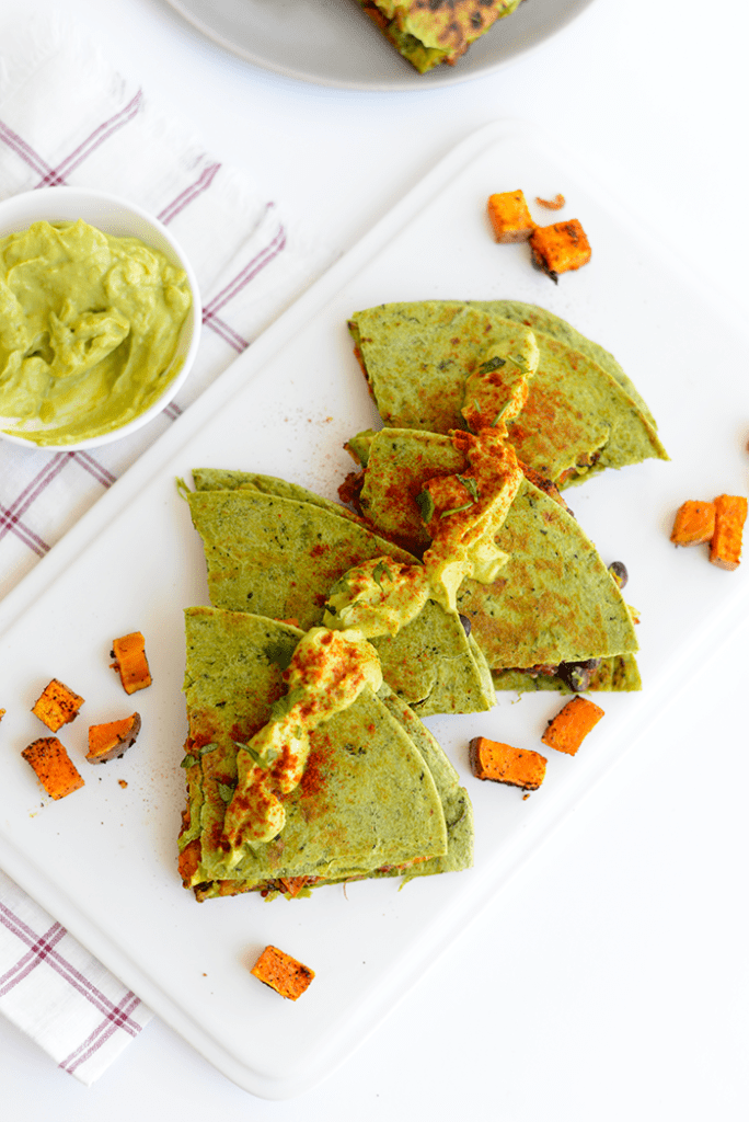 Make these cheese-free vegan sweet potato quesadillas that are packed with protein and flavor and topped with a delicious cilantro avocado spread!