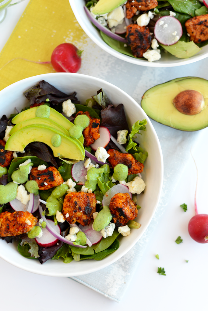 This Sriracha Chicken Salad is packed with veggies and blue cheese. It's topped with a homemade green goddess dressing that's made with a Greek yogurt base!