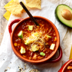 Whip out that crock-pot and pile in all of your favorite ingredients to make this stupid-easy Crock-Pot Chicken Quinoa Enchilada Soup!