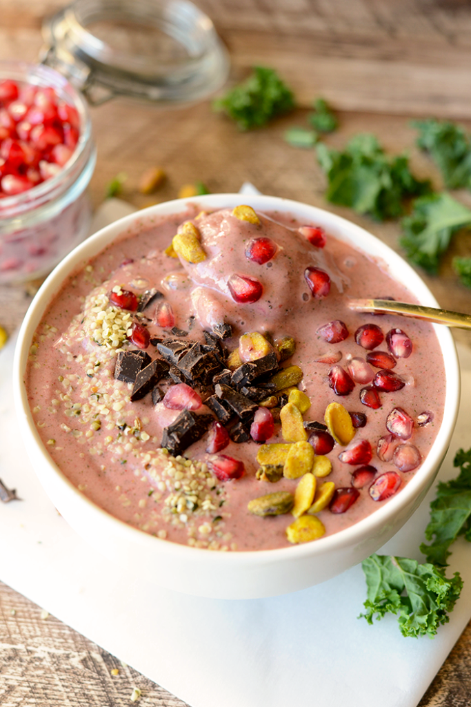 Get fancy with your smoothie and make this delicious pomegranate green smoothie bowl topped with pomegranate arils, pistachios, hemp seeds, and dark chocolate!